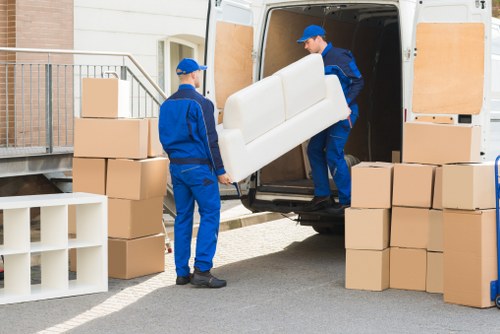 Professional movers handling same day removals in Chelsea on a busy street