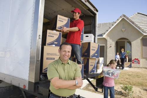 House removalists in Chelsea loading moving boxes into a truck