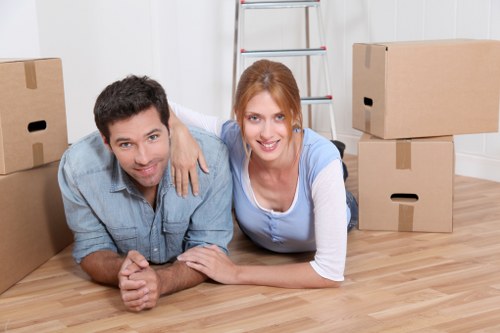 Professional movers loading furniture into a Chelsea removal van