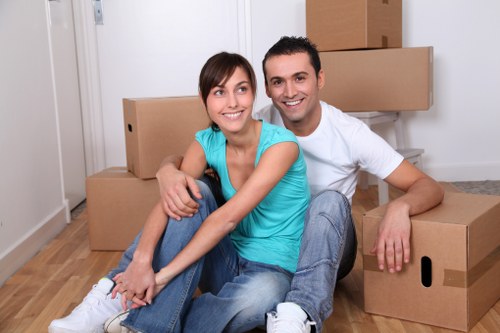 Chelsea furniture removal with moving crew carrying a wardrobe
