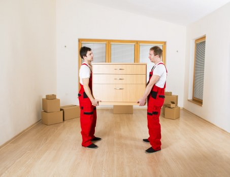 Moving team handling furniture during a van and man service